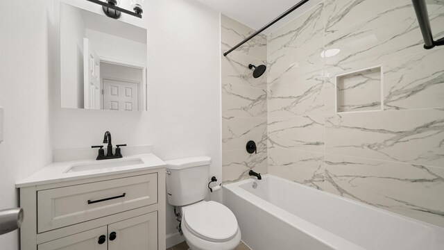 full bathroom featuring toilet, vanity, and tiled shower / bath