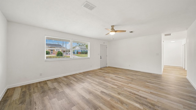 spare room with light wood-type flooring and ceiling fan