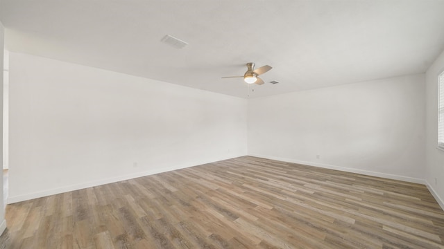 spare room with ceiling fan and light wood-type flooring