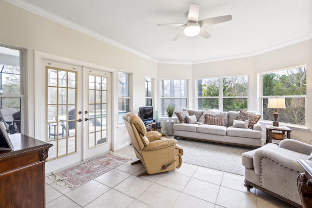 sunroom / solarium featuring french doors, plenty of natural light, and a ceiling fan