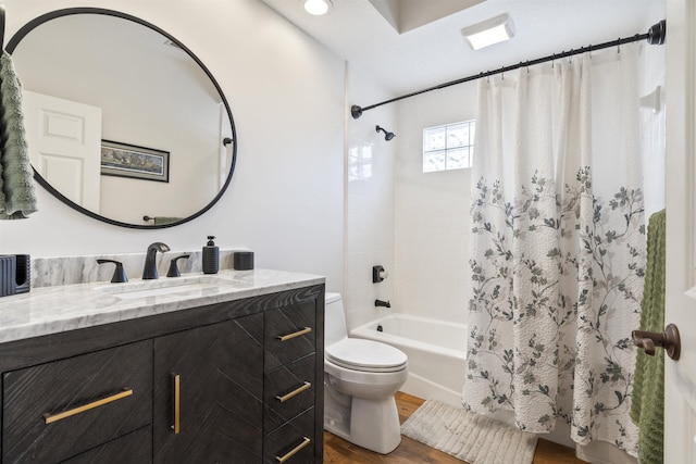 bathroom with toilet, shower / bath combo with shower curtain, wood finished floors, and vanity