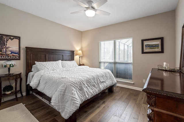 bedroom featuring ceiling fan, baseboards, and dark wood-style flooring