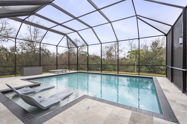 pool featuring a diving board, a patio area, and a lanai