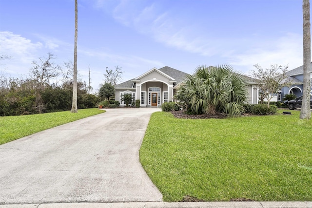 view of front of home featuring french doors, a front lawn, and concrete driveway