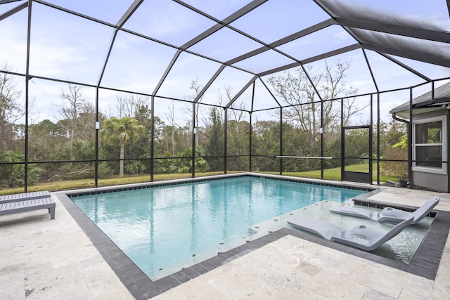 pool with a lanai and a patio area