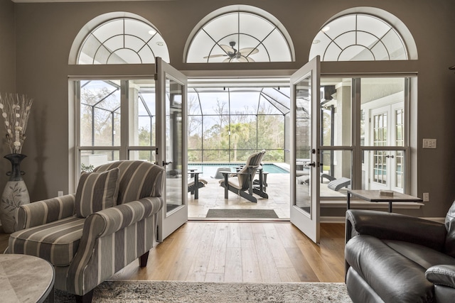 living room with french doors, wood finished floors, and a sunroom