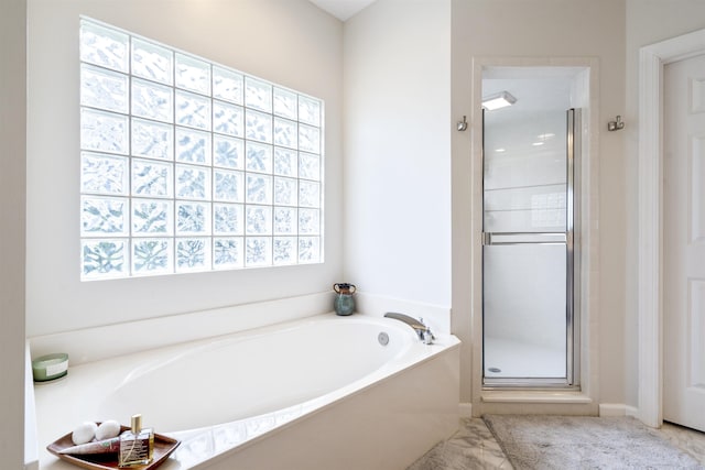 full bath with a garden tub and a stall shower