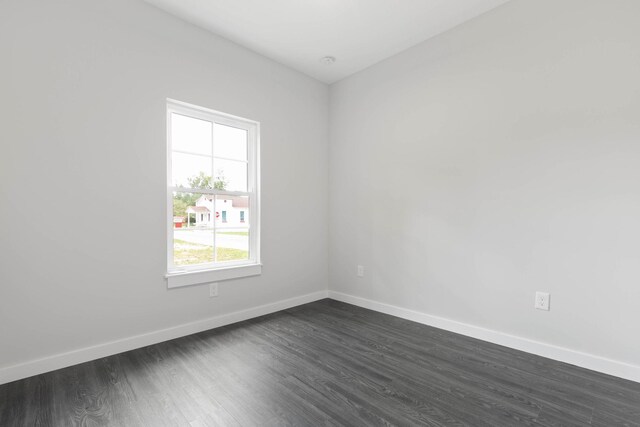 empty room with dark wood-type flooring