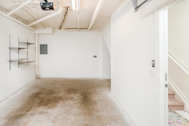 garage with a garage door opener and electric panel