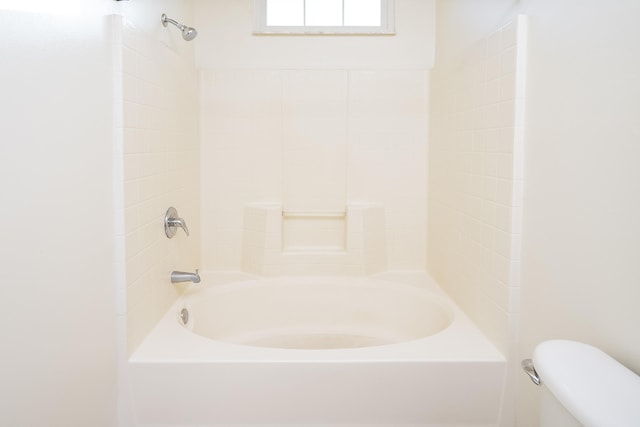 bathroom featuring toilet and shower / bathing tub combination