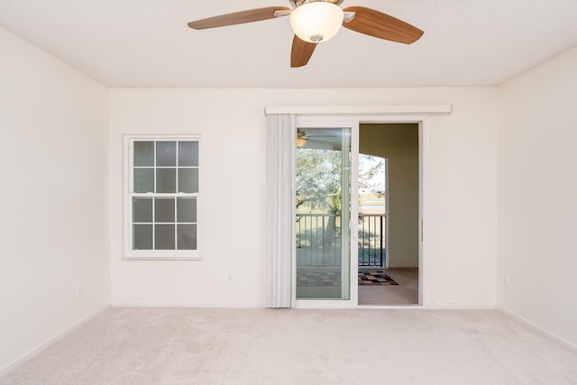 spare room with light carpet and a textured ceiling