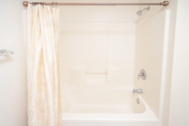 bathroom with shower / tub combo with curtain