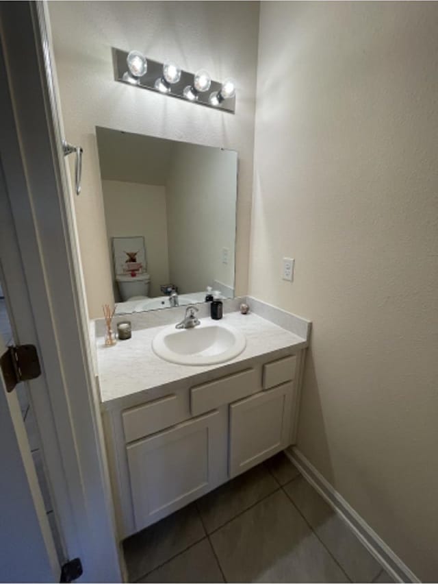 bathroom with vanity, tile patterned floors, and toilet