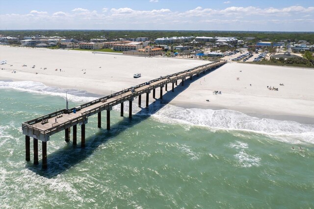 birds eye view of property with a water view and a beach view