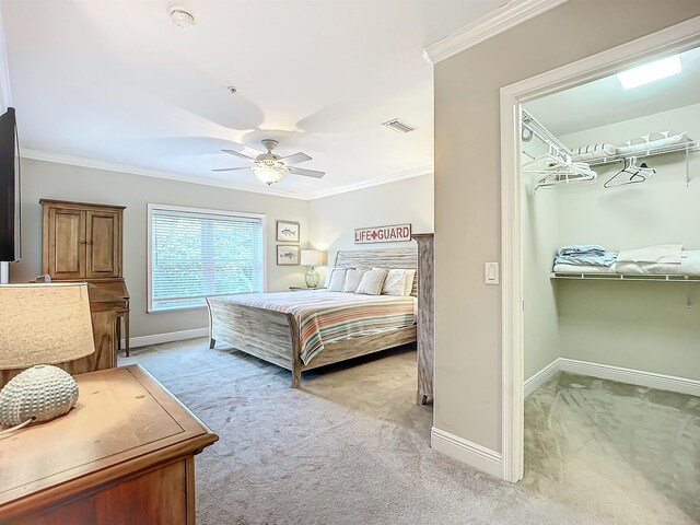 carpeted bedroom with ceiling fan and crown molding