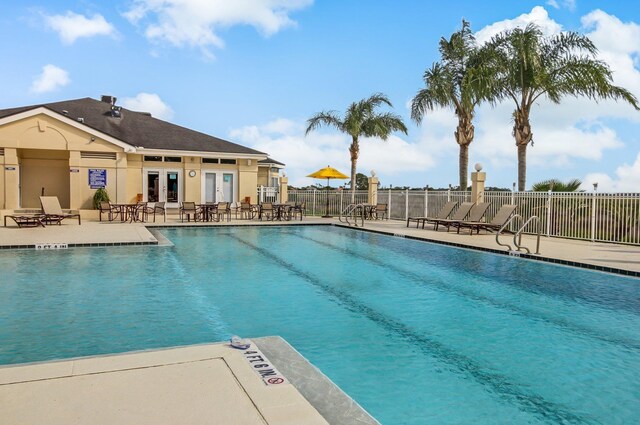 613 Wild Bird Ln, Saint Augustine, FL 32080 - community pool featuring french doors, fence, and a patio