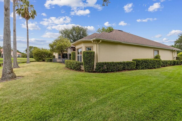 613 Wild Bird Ln, Saint Augustine, FL 32080 - view of property exterior with stucco siding and a lawn