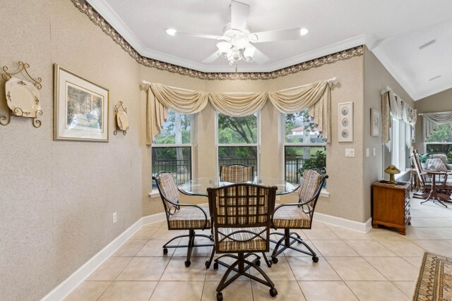 613 Wild Bird Ln, Saint Augustine, FL 32080 - dining room featuring crown molding, a ceiling fan, light tile patterned floors, and baseboards