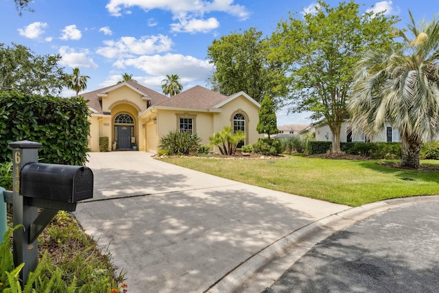 613 Wild Bird Ln, Saint Augustine, FL 32080 - mediterranean / spanish-style home featuring stucco siding, a garage, concrete driveway, and a front lawn