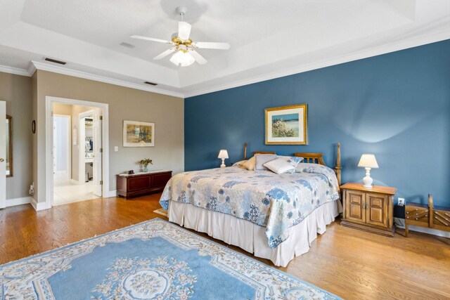 613 Wild Bird Ln, Saint Augustine, FL 32080 - bedroom with wood finished floors, a raised ceiling, ornamental molding, ceiling fan, and baseboards