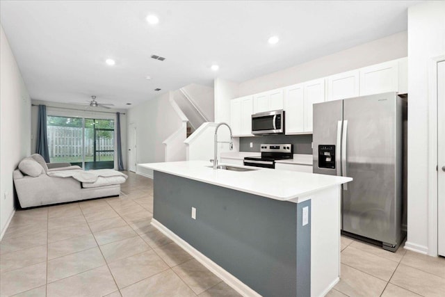 180 Stonegate Ave, Saint Augustine, FL 32084 - kitchen featuring appliances with stainless steel finishes, a sink, white cabinets, light tile patterned floors, and recessed lighting