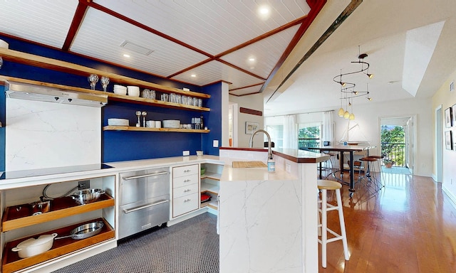 12 Flagler Blvd Unit B201, Saint Augustine, FL 32080 - kitchen with open shelves, a warming drawer, a breakfast bar area, recessed lighting, and dark wood-style flooring