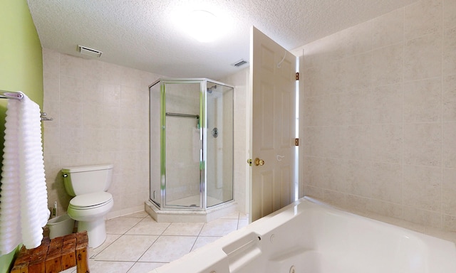 12 Flagler Blvd Unit B201, Saint Augustine, FL 32080 - full bathroom featuring tile walls, a shower stall, tile patterned flooring, a whirlpool tub, and toilet