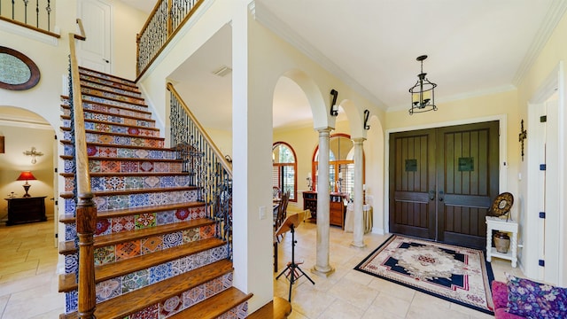 84 Villa Sovana Ct, Saint Johns, FL 32259 - entryway featuring arched walkways, crown molding, stairs, decorative columns, and light tile patterned floors