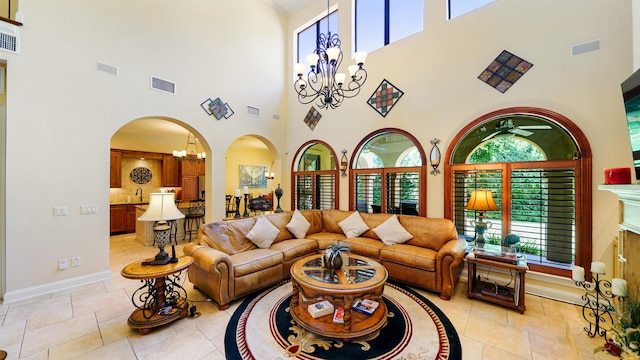 84 Villa Sovana Ct, Saint Johns, FL 32259 - living room featuring a chandelier, a towering ceiling, plenty of natural light, arched walkways, and ceiling fan