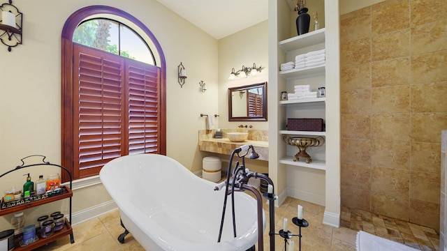 84 Villa Sovana Ct, Saint Johns, FL 32259 - bathroom with a freestanding bath, tile patterned floors, and built in shelves