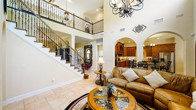 84 Villa Sovana Ct, Saint Johns, FL 32259 - living area with a chandelier, a high ceiling, stairs, arched walkways, and recessed lighting