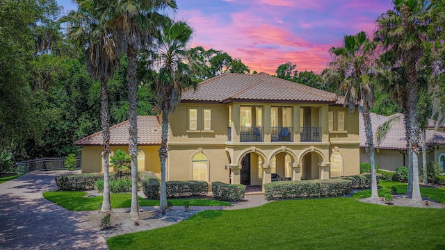 84 Villa Sovana Ct, Saint Johns, FL 32259 - mediterranean / spanish-style house featuring a balcony, a tiled roof, stucco siding, and a porch