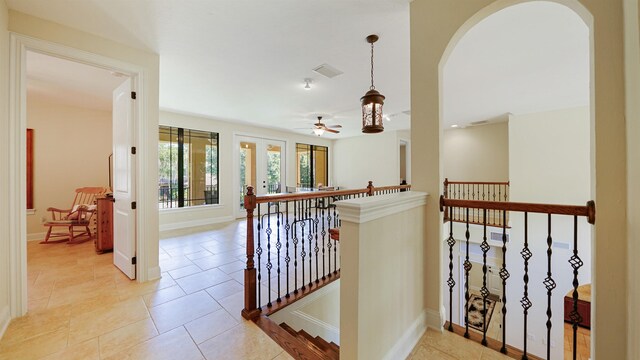 84 Villa Sovana Ct, Saint Johns, FL 32259 - hall with an upstairs landing, arched walkways, and light tile patterned floors