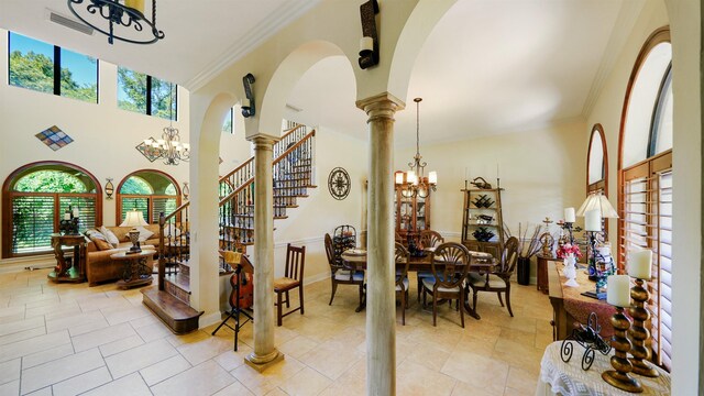 84 Villa Sovana Ct, Saint Johns, FL 32259 - foyer with a chandelier, arched walkways, crown molding, and decorative columns