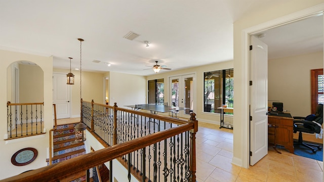 84 Villa Sovana Ct, Saint Johns, FL 32259 - hallway featuring french doors, a desk, light tile patterned floors, an upstairs landing, and arched walkways