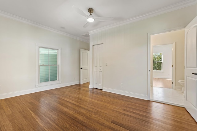 empty room featuring hardwood / wood-style flooring, ceiling fan, and ornamental molding