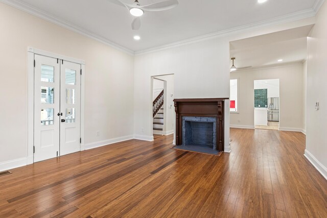 unfurnished living room with hardwood / wood-style flooring, ceiling fan, and ornamental molding