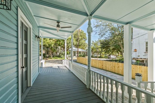 unfurnished sunroom featuring ceiling fan