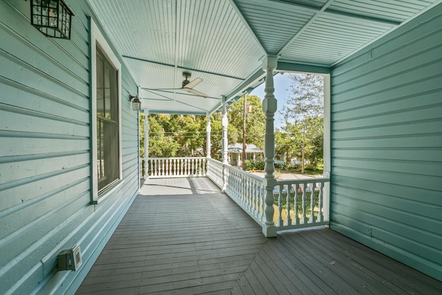 deck with ceiling fan and covered porch