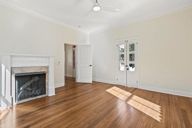 unfurnished living room featuring ceiling fan, dark hardwood / wood-style flooring, and crown molding