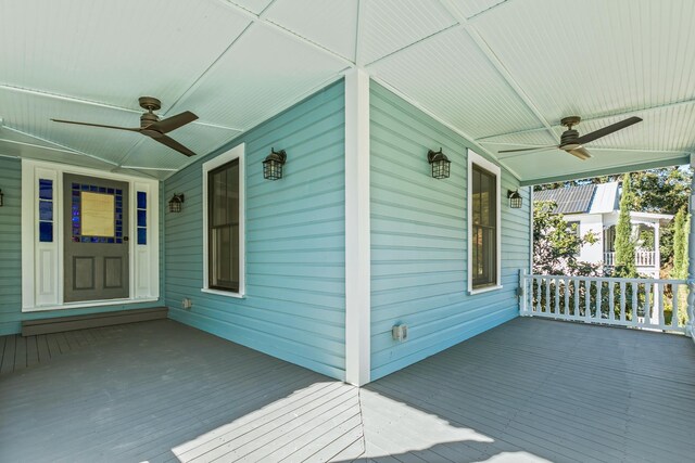 wooden terrace with ceiling fan and a porch