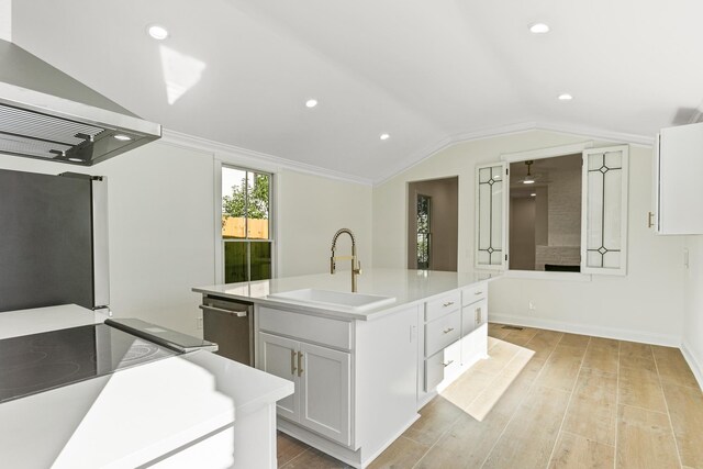 kitchen featuring a center island with sink, white cabinets, vaulted ceiling, light wood-type flooring, and island exhaust hood