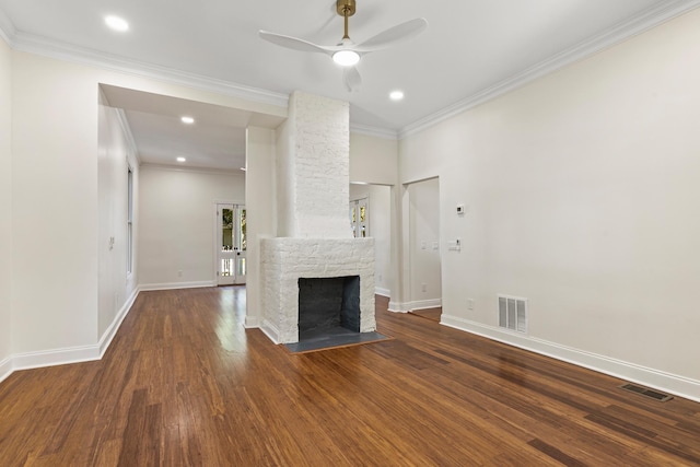 unfurnished living room featuring ceiling fan, dark hardwood / wood-style flooring, ornamental molding, and a fireplace