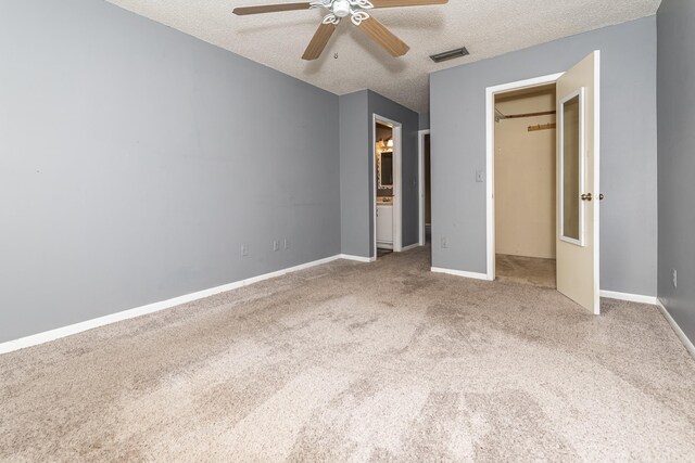 unfurnished bedroom with carpet flooring, ceiling fan, and a textured ceiling