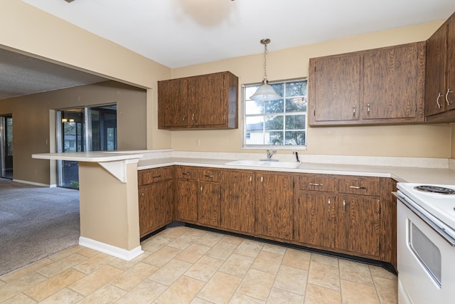 kitchen with sink, hanging light fixtures, kitchen peninsula, light colored carpet, and electric stove