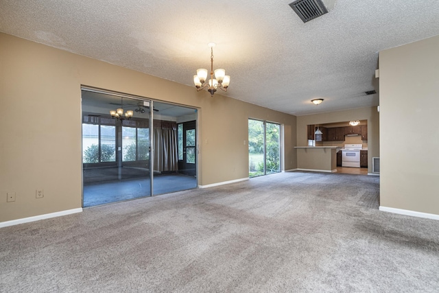 unfurnished living room featuring carpet, a textured ceiling, and a chandelier