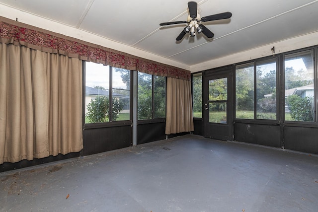 unfurnished sunroom featuring ceiling fan