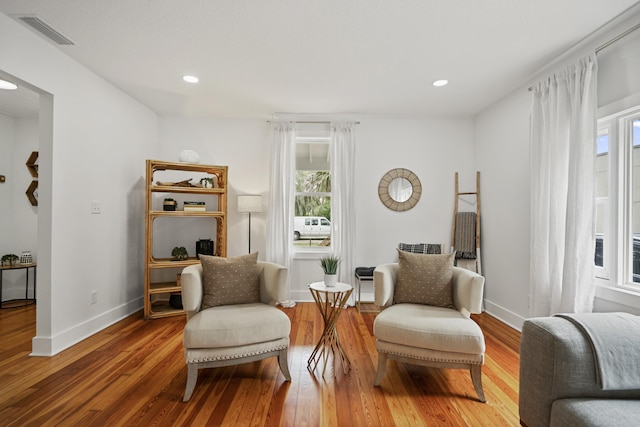 sitting room with hardwood / wood-style flooring