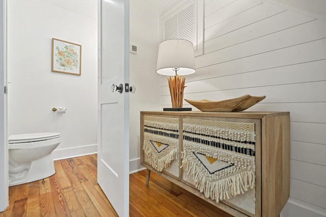 bathroom with wood-type flooring and toilet