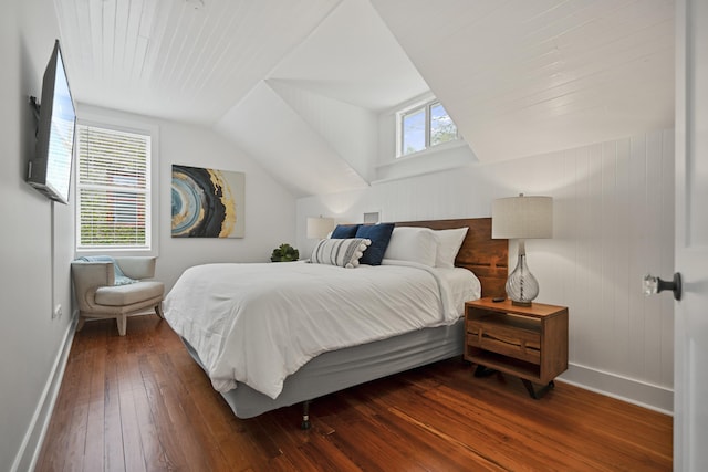 bedroom featuring multiple windows, lofted ceiling, and dark wood-type flooring